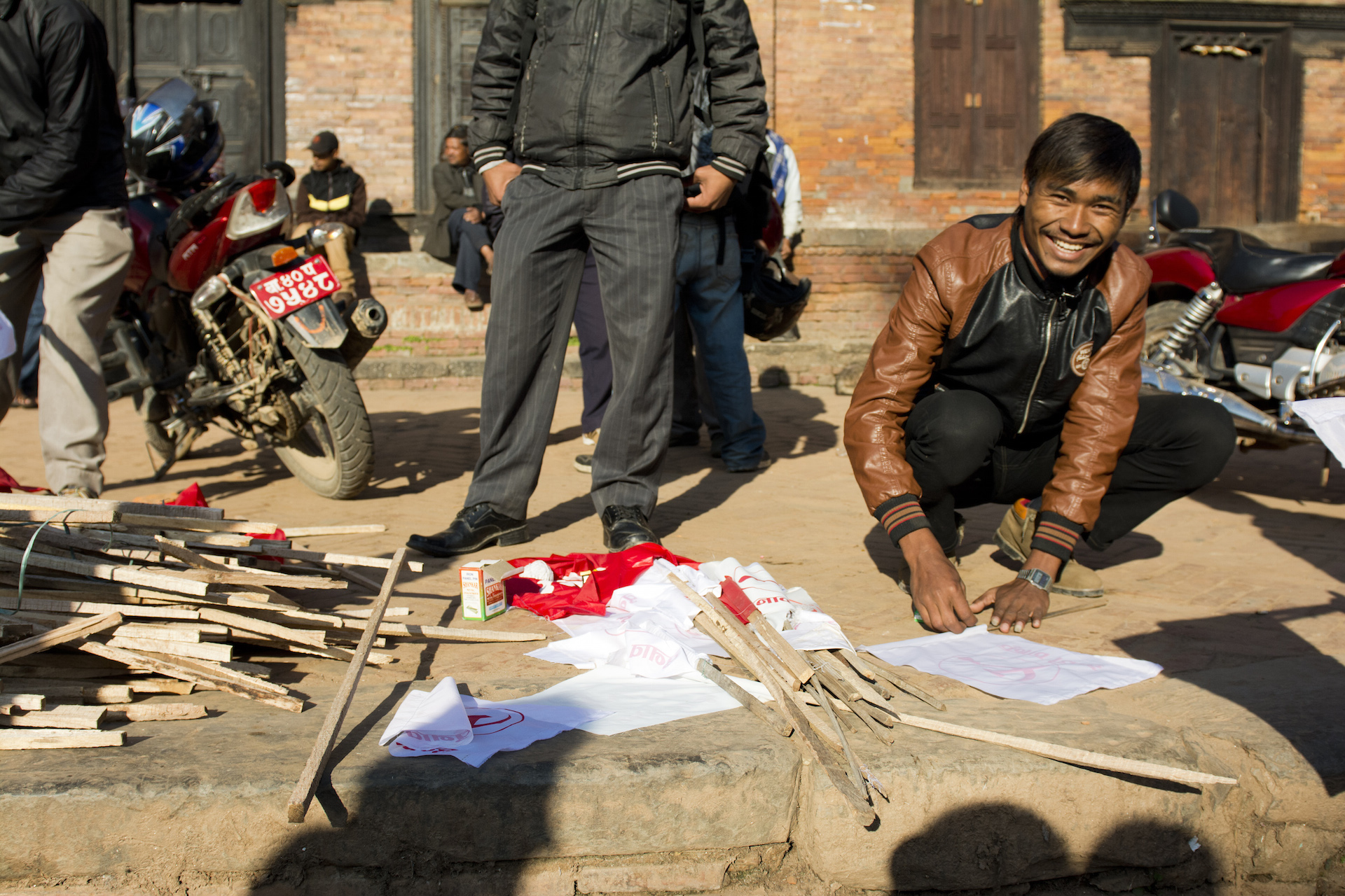 A Nepali man prepares flags for a political rally in Kathmandu. The flags were held up by motorcyclists as they wound through Kathmandu's narrow streets.